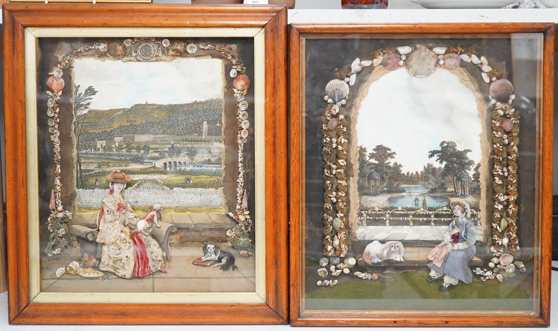 Two 18th century and later prints, watercolours and collages, Seated women and dogs before landscapes, each with shellwork borders, 40 x 33cm, maple framed